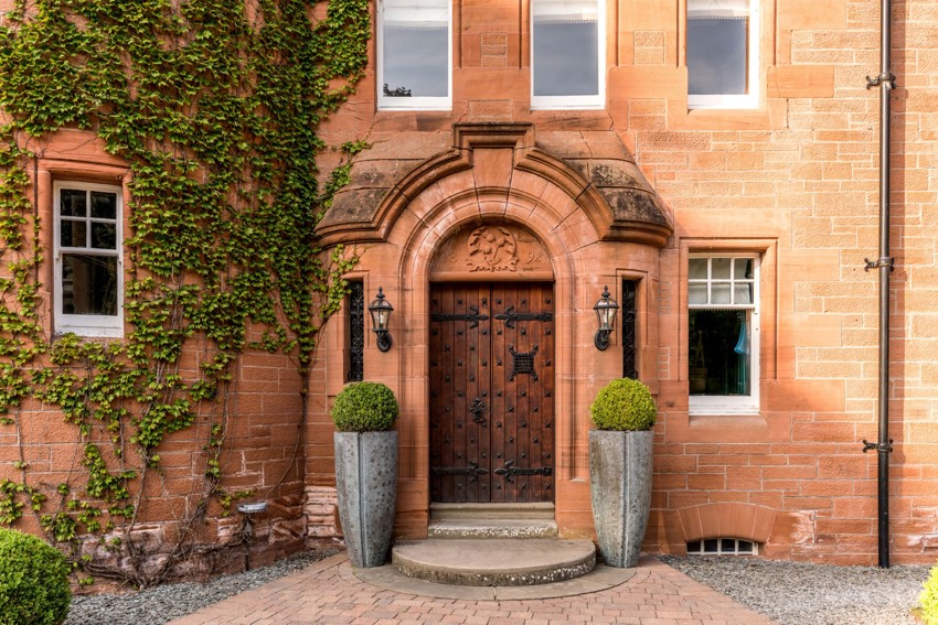 Fonab Castle | Wooden Castle Doors Surrounded by Brick With Ivy at Fonab Castle Hotel in Pitlochry ?? Fonab Castle