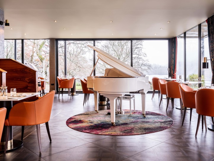 Fonab Castle | White Grand Piano in Pitlochry hotel restaurant with floor to ceiling windows backdrop ?? Fonab Castle